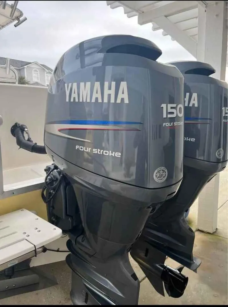 Slide: The Image of Yamaha 150 four-stroke outboard motors on a 2008 Clearwater 2500 boat. - 12