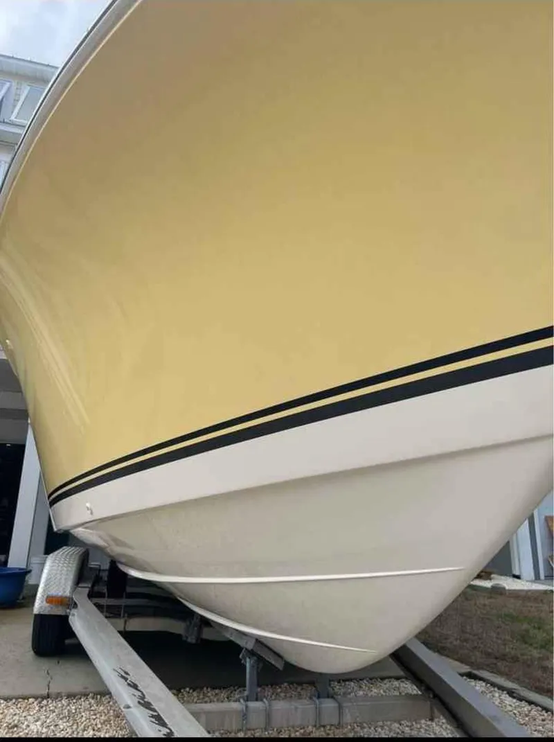 Slide: The Image of 2008 Clearwater 2500 boat with yellow hull on trailer, side view. - 4
