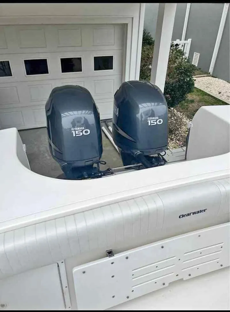 Slide: The Image of 2008 Clearwater 2500 boat with dual Yamaha 150 outboard motors in a garage setting. - 6