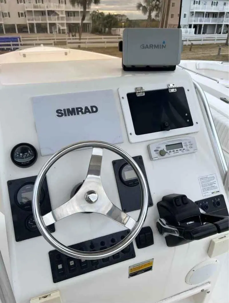 Slide: The Image of Boat dashboard with steering wheel, Simrad and Garmin navigation systems, Clearwater 2500, 2008 model. - 7