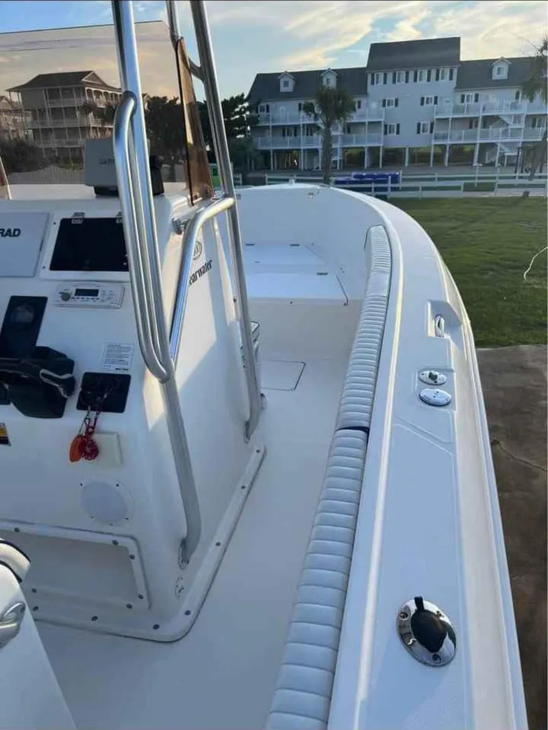 Slide: The Image of 2008 Clearwater 2500 boat with console, docked near waterfront buildings. - 9