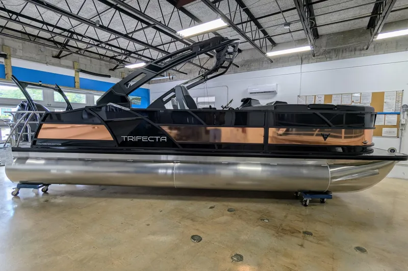 Slide: The Image of 2026 Trifecta 23UL SS ARCH pontoon boat in showroom, sleek design, modern features. - 5
