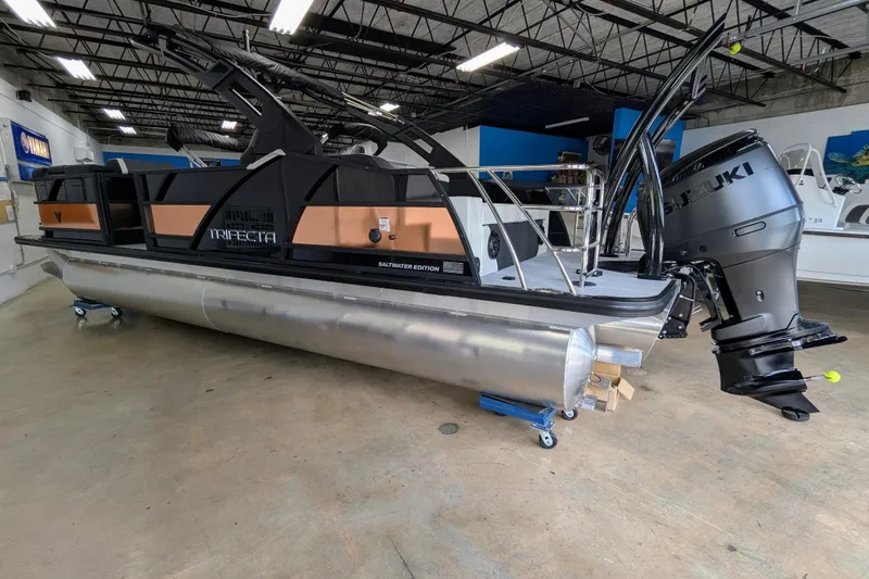 Slide: The Image of 2026 Trifecta 23UL SS ARCH pontoon boat with Suzuki outboard motor in showroom. - 6