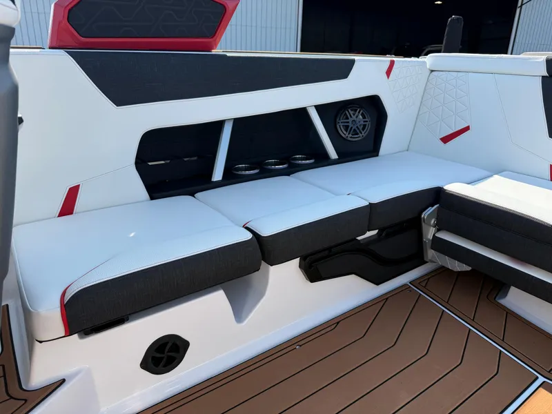 Slide: The Image of 2025 Nautique Super Air Nautique GS22 interior seating with modern design and cup holders. - 11