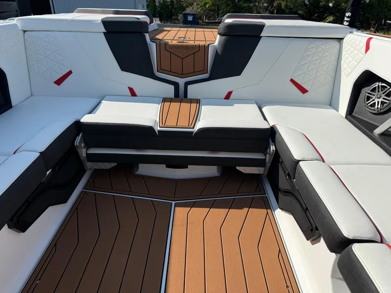 Slide: The Image of 2025 Nautique Super Air Nautique GS22 interior with stylish seating and teak flooring. - 12