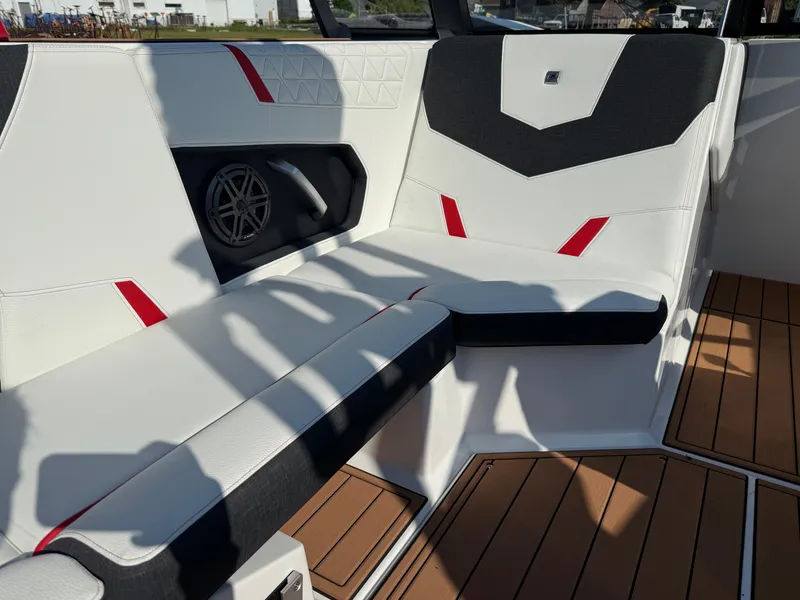 Slide: The Image of 2025 Nautique Super Air Nautique GS22 interior with stylish seating and speaker system. - 14