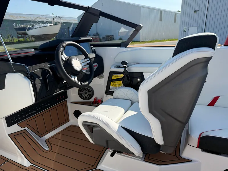 Slide: The Image of 2025 Nautique Super Air Nautique GS22 cockpit with modern steering and seating. - 15