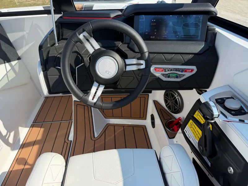 Slide: The Image of 2025 Nautique Super Air Nautique GS22 cockpit with modern steering and digital display. - 16