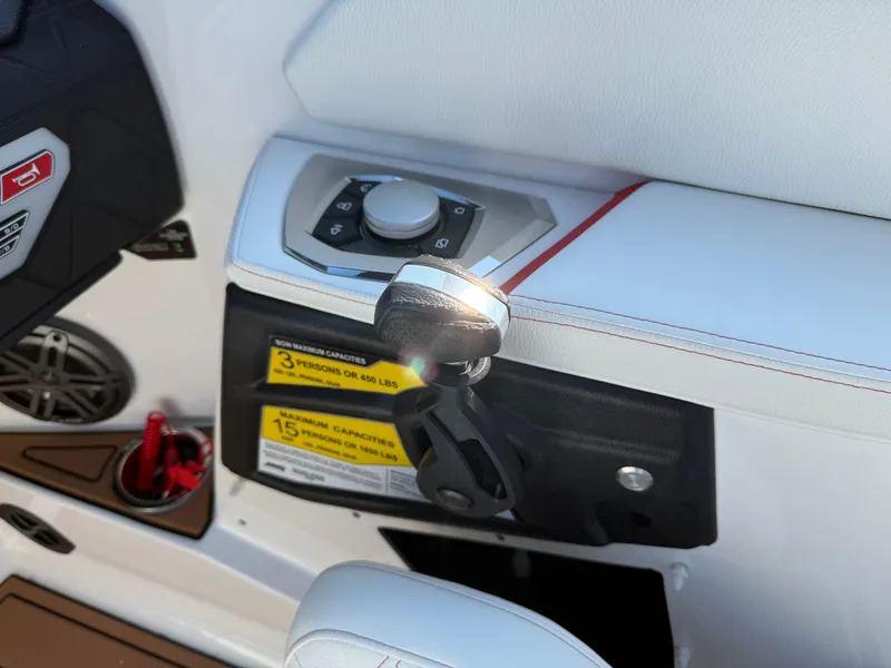 Slide: The Image of Interior controls of 2025 Nautique Super Air Nautique GS22 boat, featuring sleek design and capacity labels. - 17