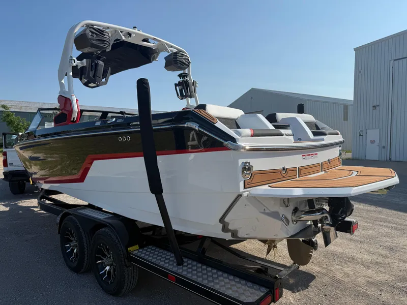Slide: The Image of 2025 Nautique Super Air Nautique GS22 boat on trailer, rear view, sunny day. - 2