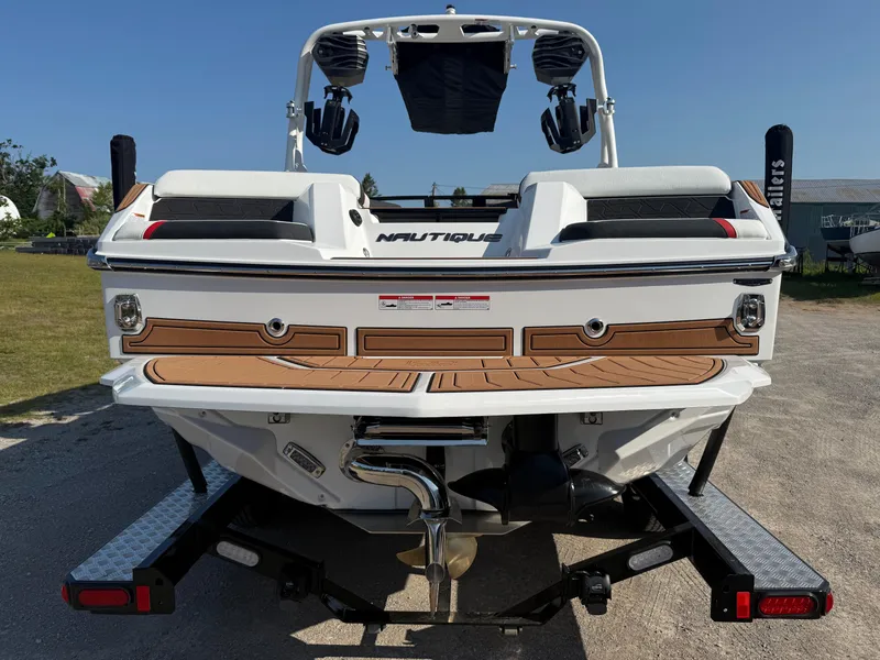 Slide: The Image of 2025 Nautique Super Air Nautique GS22 boat on trailer, rear view, sunny day. - 3