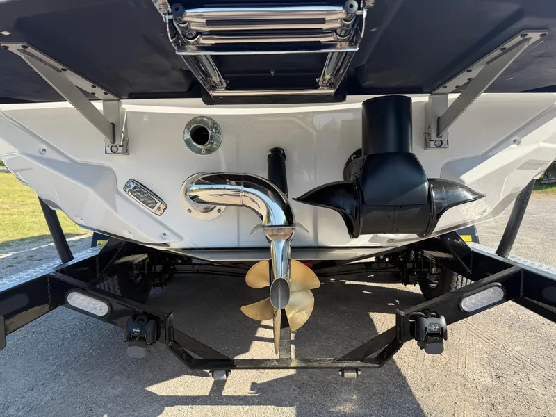 Slide: The Image of 2025 Nautique Super Air Nautique GS22 boat stern with propeller and exhaust system. - 4