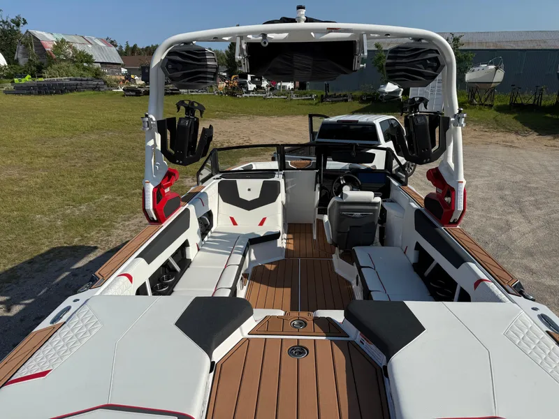 Slide: The Image of 2025 Nautique Super Air Nautique GS22 boat interior with seating and sound system. - 9
