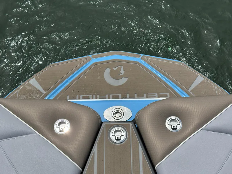 Slide: The Image of 2025 Centurion NV233 boat deck with logo, floating on water. - 16