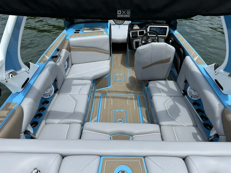 Slide: The Image of Luxurious 2025 Centurion NV233 boat interior with modern seating and advanced dashboard. - 17