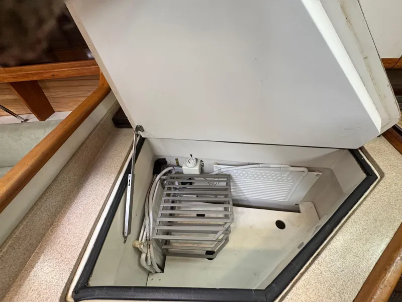 Slide: The Image of Open storage compartment on a 1995 Catalina 400 yacht, featuring a metal rack and cables. - 13