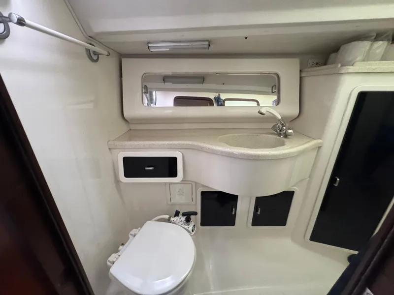 Slide: The Image of 1995 Catalina 400 yacht bathroom with sink, toilet, and storage cabinets. - 17