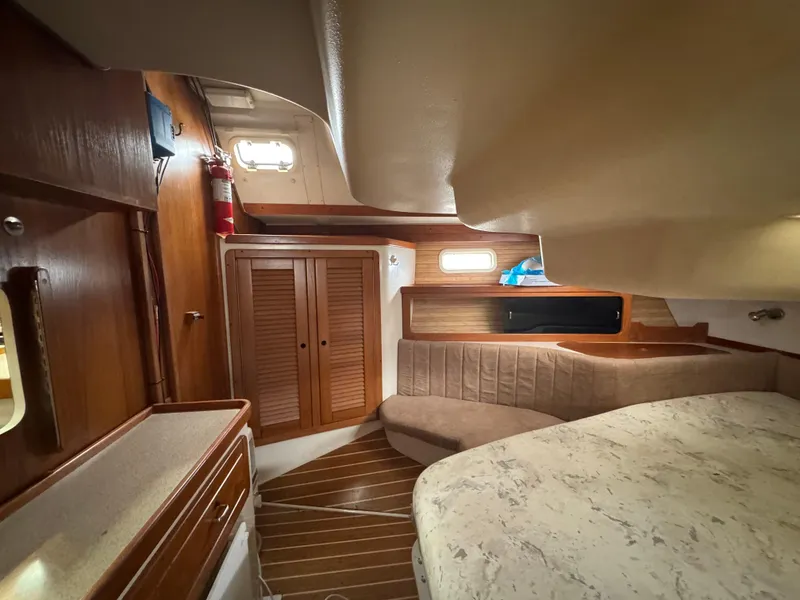 Slide: The Image of Interior of 1995 Catalina 400 sailboat with wood finishes and cozy seating area. - 22