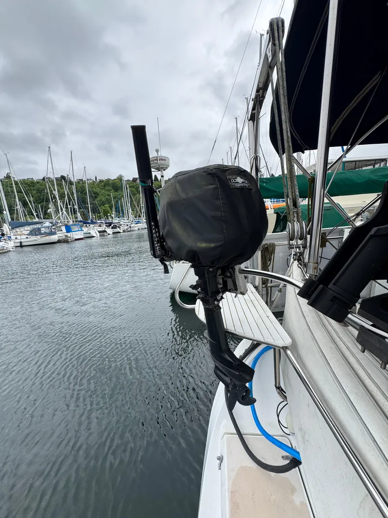 Slide: The Image of Catalina 400 sailboat docked at marina, featuring covered outboard motor, overcast sky. - 28