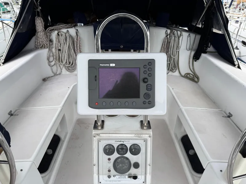 Slide: The Image of Cockpit of 1995 Catalina 400 sailboat with navigation equipment and ropes. - 29