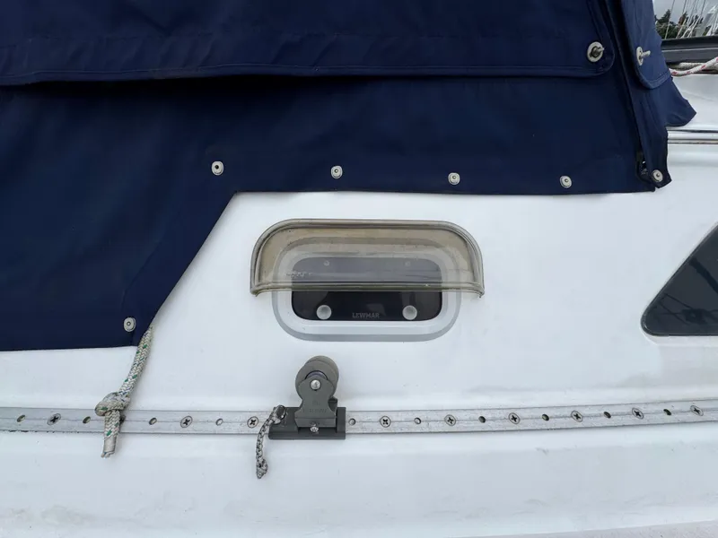 Slide: The Image of Close-up of a 1995 Catalina 400 sailboat deck with blue canvas cover. - 35