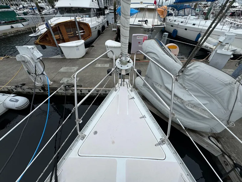 Slide: The Image of Bow view of 1995 Catalina 400 sailboat docked at marina with other boats. - 39