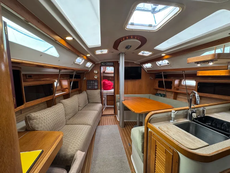 Slide: The Image of Interior of a 1995 Catalina 400 sailboat with cozy seating and modern amenities. - 4