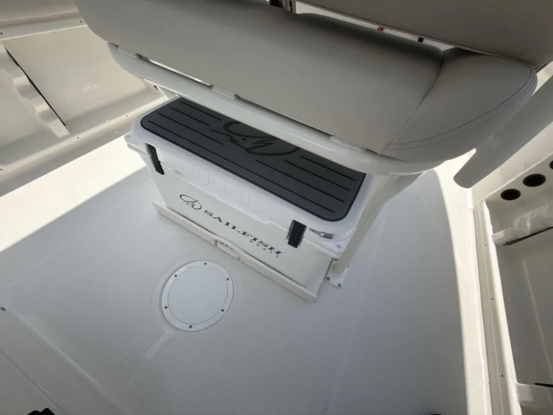 Slide: The Image of 2025 Sailfish 232 CC boat interior with cushioned seating and storage compartment. - 10