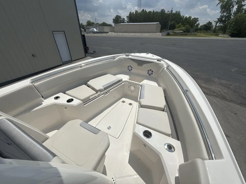 Slide: The Image of 2025 Sailfish 232 CC boat interior with cushioned seating and cup holders. - 12