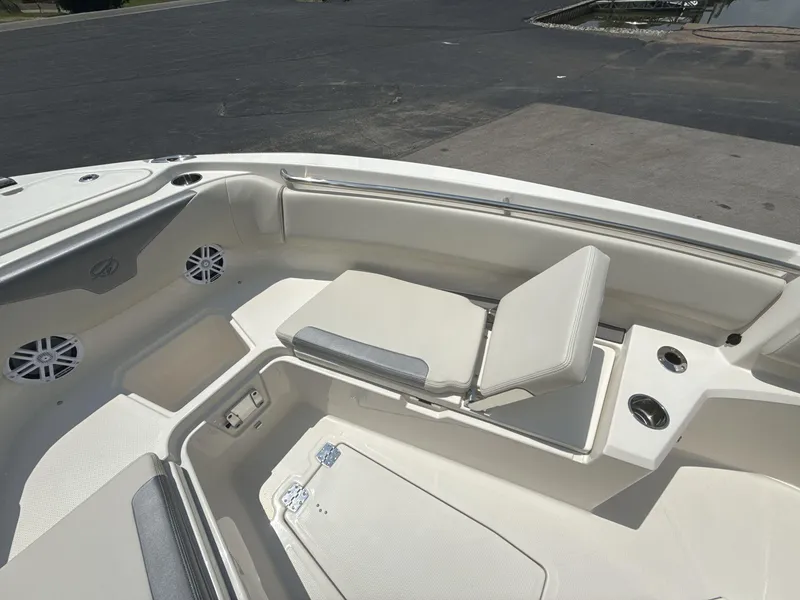 Slide: The Image of 2025 Sailfish 232 CC boat interior with cushioned seating and cup holders. - 13