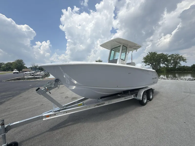Slide: The Image of 2025 Sailfish 232 CC boat on trailer under cloudy sky. - 2
