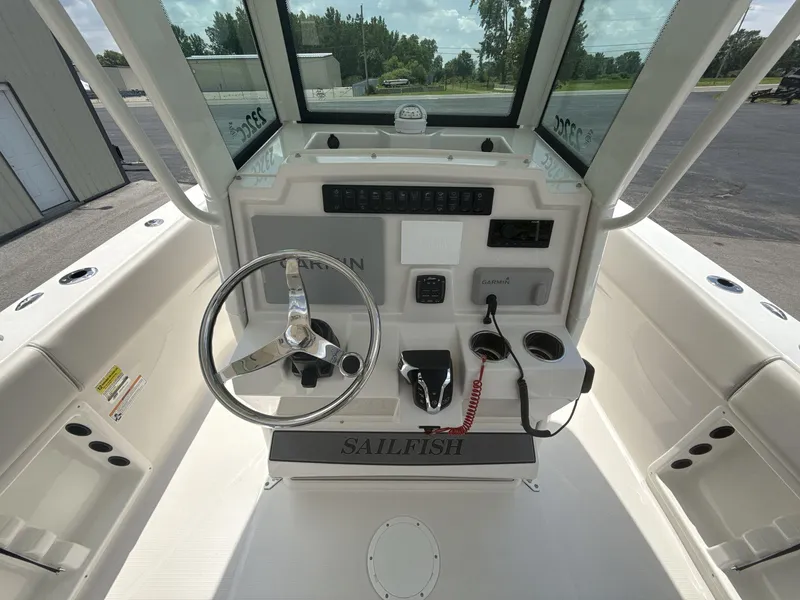 Slide: The Image of 2025 Sailfish 232 CC boat console with steering wheel and navigation controls. - 7