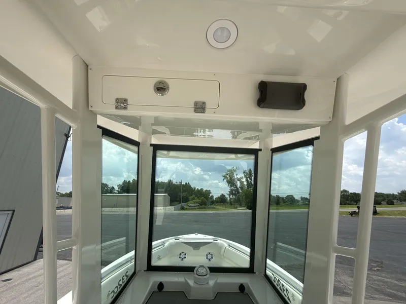 Slide: The Image of Interior view of 2025 Sailfish 232 CC boat with clear windows and storage compartment. - 8