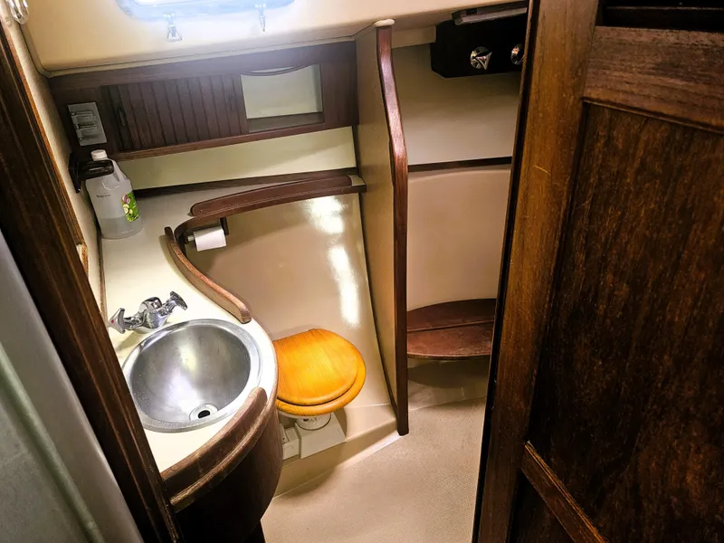 Slide: The Image of 1990 Island Packet 35 yacht bathroom with sink, wooden accents, and compact design. - 11