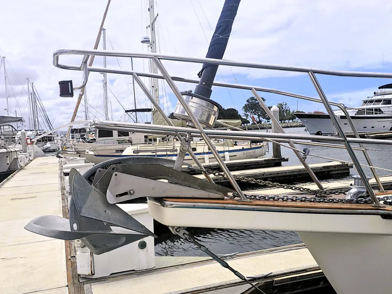 Slide: The Image of Island Packet 35 sailboat docked at marina, showcasing anchor and bow details. - 16