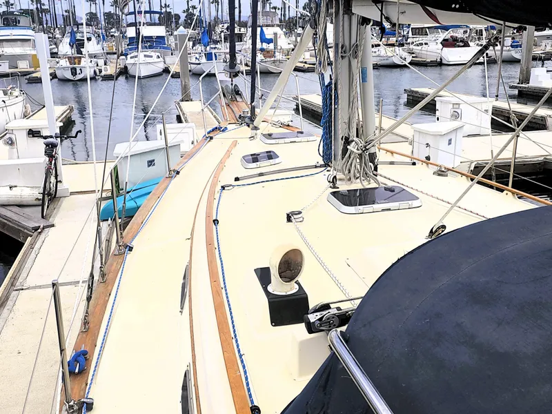 Slide: The Image of Sailboat docked at marina, Island Packet 35, 1990 model, with visible deck and rigging. - 18