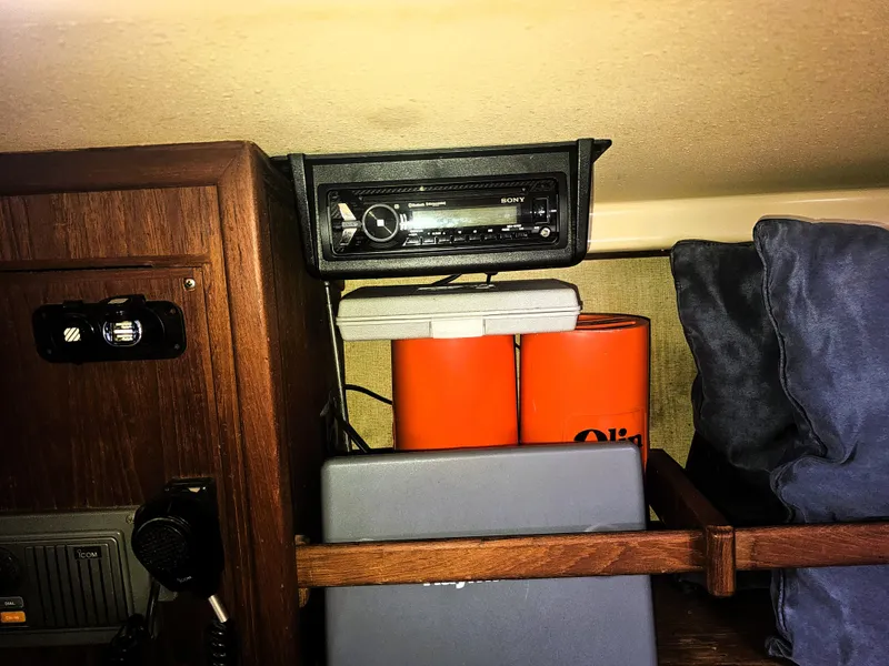 Slide: The Image of Interior of a 1990 Island Packet 35 sailboat with radio and storage items. - 21
