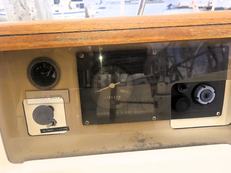 Slide: The Image of 1990 Island Packet 35 sailboat dashboard with gauges and controls. - 26