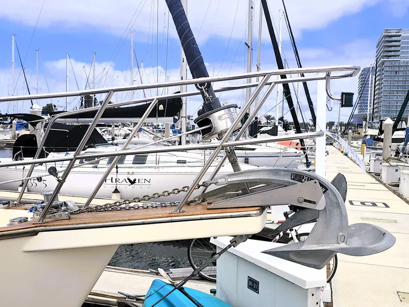 Slide: The Image of 1990 Island Packet 35 sailboat docked at marina with anchor and railing visible. - 27