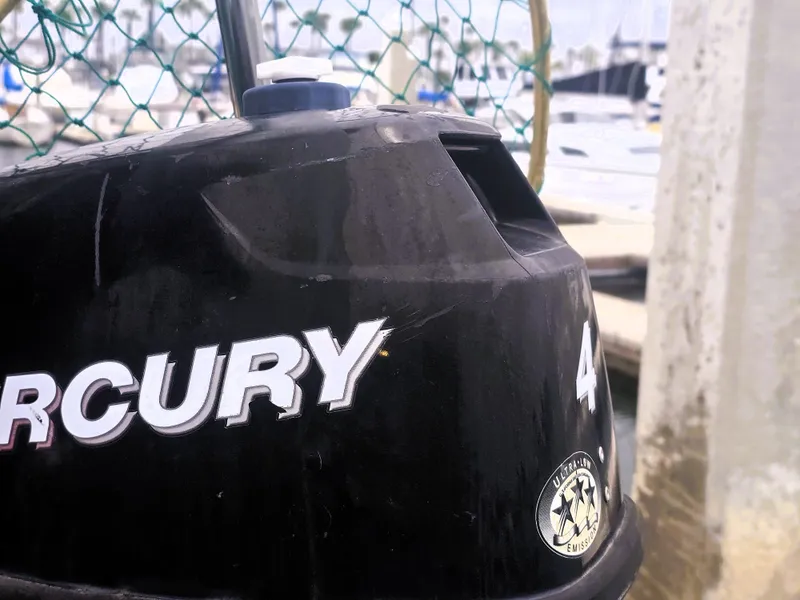 Slide: The Image of Outboard motor close-up with marina background, Island Packet 35, 1990 model. - 30