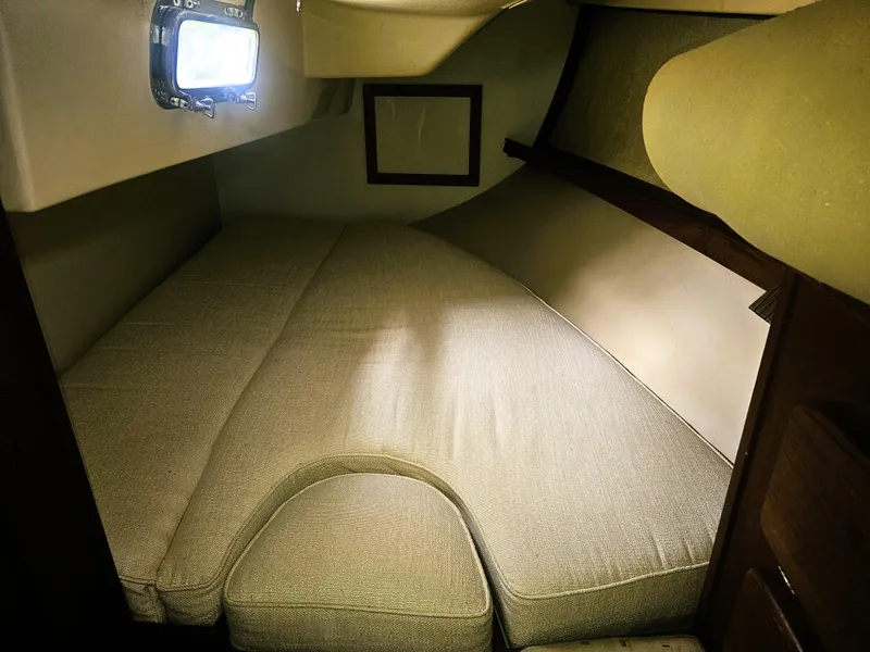Slide: The Image of Cozy cabin interior of 1990 Island Packet 35 sailboat with cushioned berth. - 8