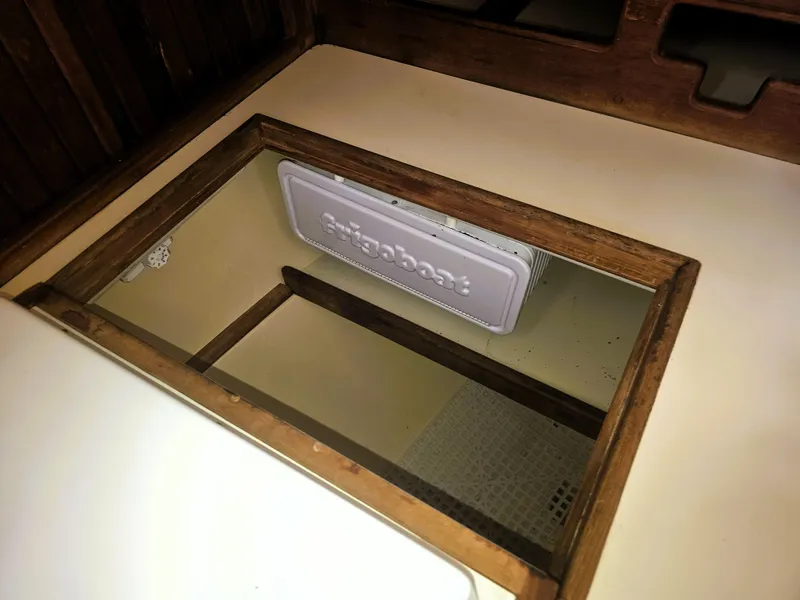 Slide: The Image of Wooden hatch with storage compartment on 1990 Island Packet 35 sailboat. - 9