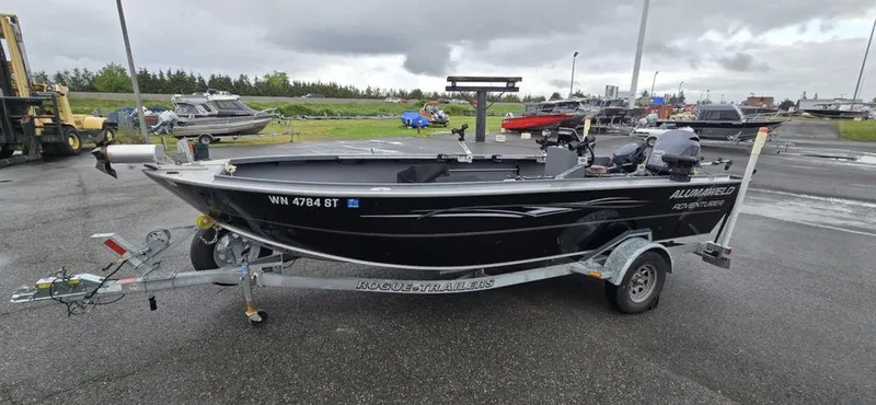 Slide: The Image of 2019 Alumaweld 20 Adventure boat on trailer in parking lot, overcast sky. - 1