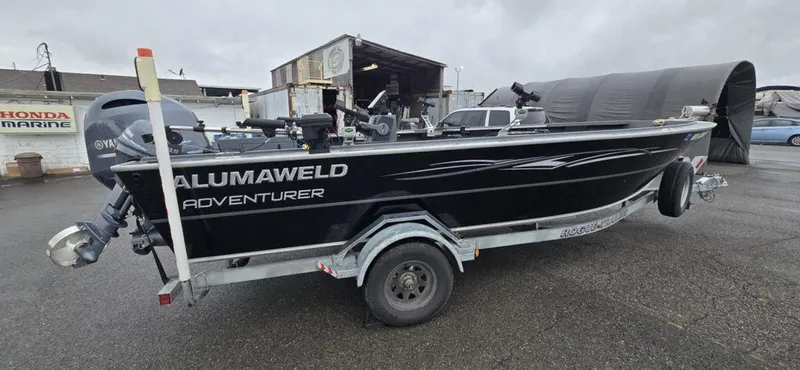 Slide: The Image of 2019 Alumaweld 20 Adventure boat on trailer, parked outdoors, overcast sky. - 4