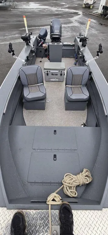Slide: The Image of 2019 Alumaweld 20 Adventure boat interior with seating and equipment on a wet dock. - 8