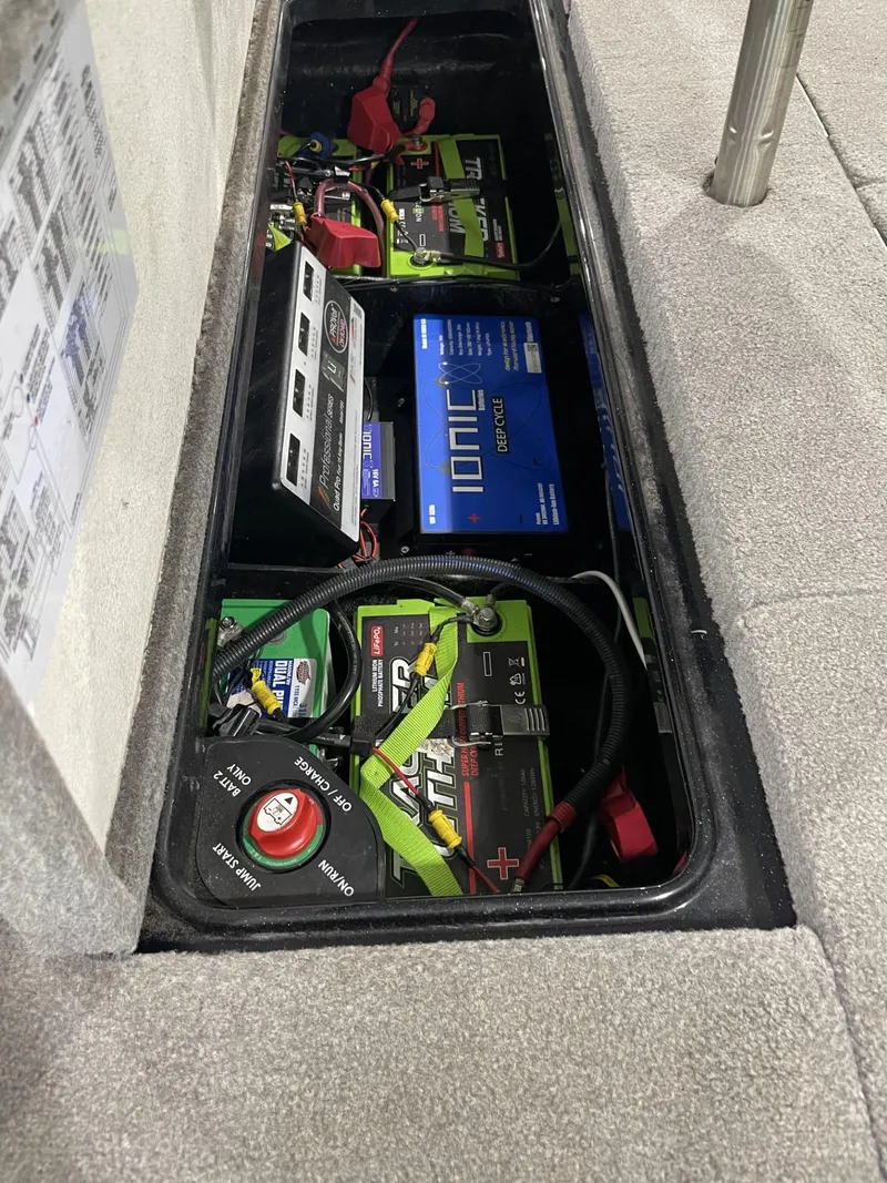 Slide: The Image of Battery compartment of a 2021 Ranger Z521L boat with multiple batteries and wiring. - 2