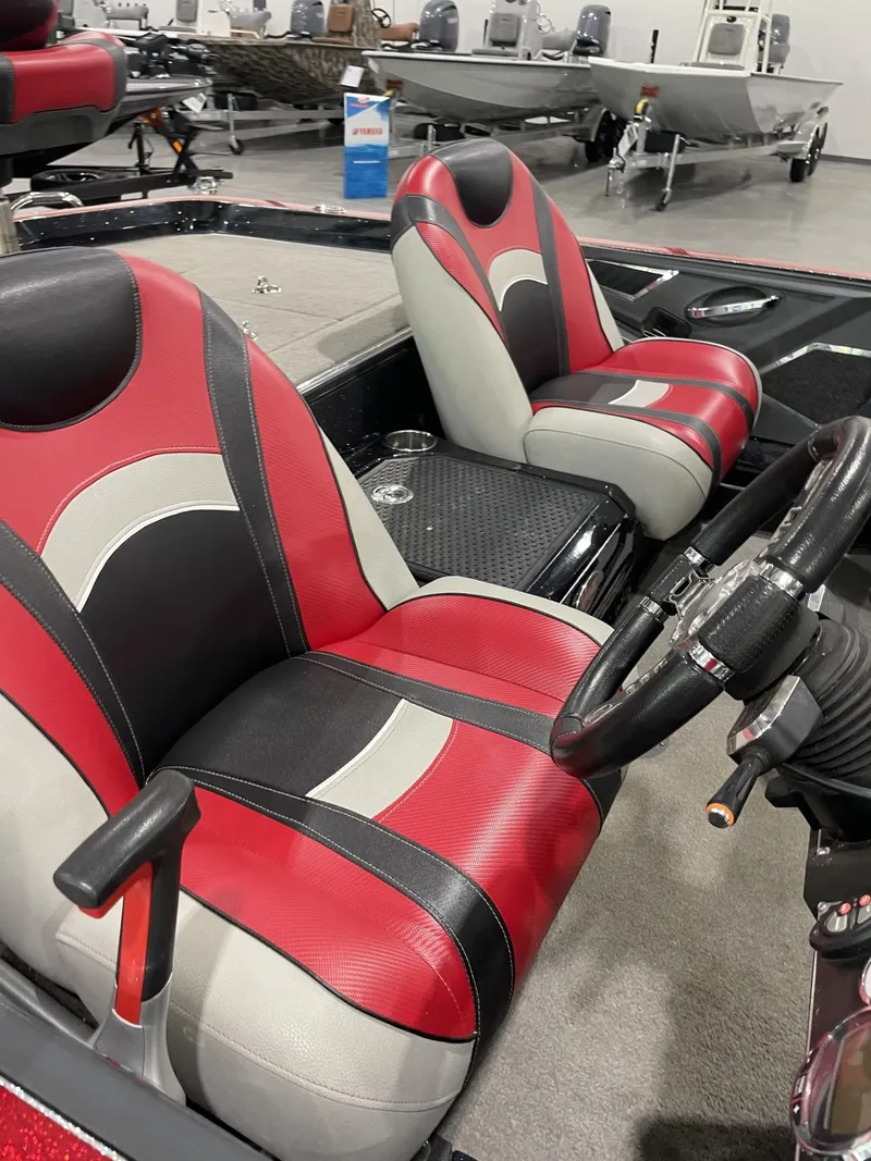Slide: The Image of 2021 Ranger Z521L boat interior with red and black seats, steering wheel, and console. - 5