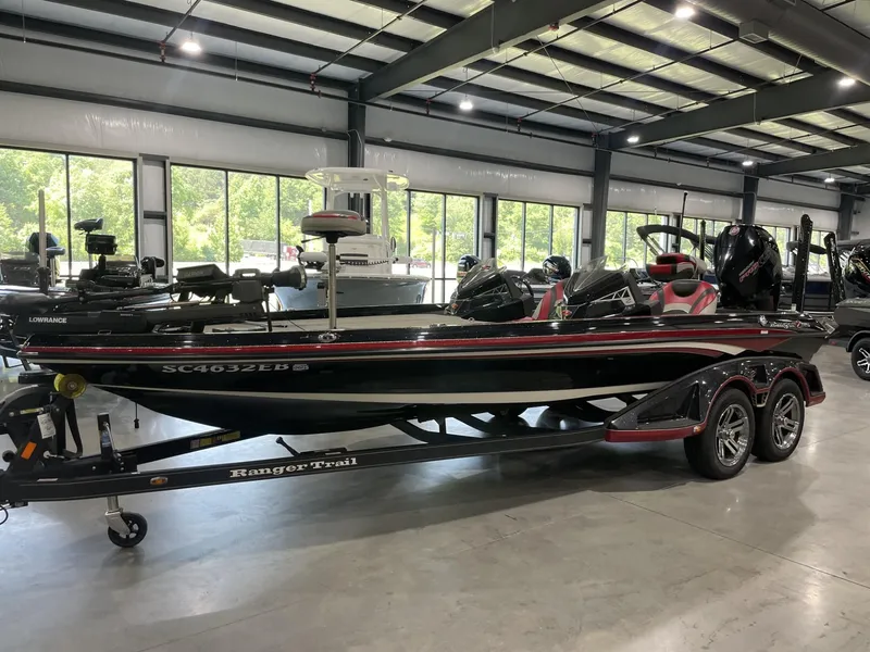 Slide: The Image of 2021 Ranger Z521L boat in showroom, black and red design, on trailer. - 9