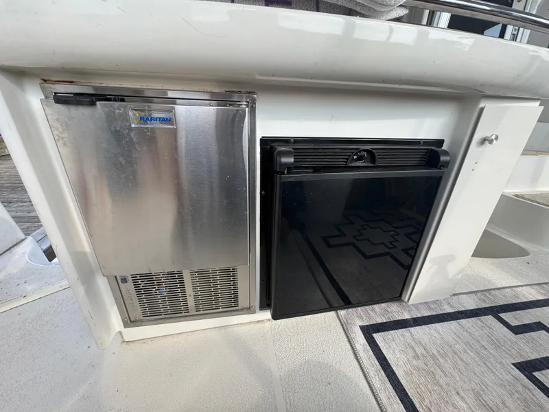Slide: The Image of Carver 504 Cockpit Motor Yacht 2000 with stainless steel appliances and storage compartment. - 14
