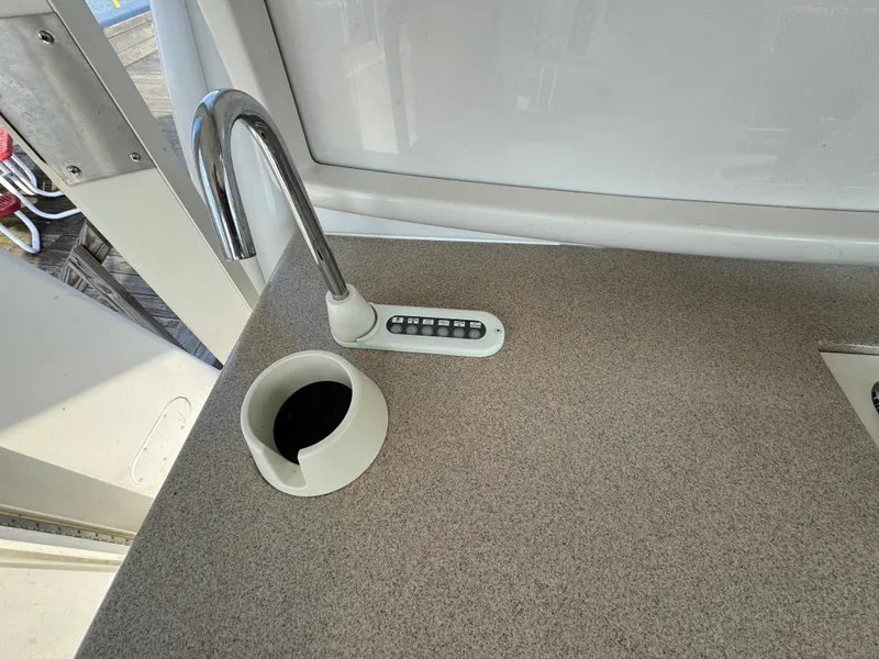 Slide: The Image of Carver 504 Cockpit Motor Yacht 2000, kitchen sink area with faucet and cup holder. - 15